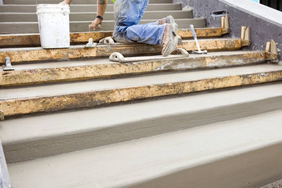 a person is making steps with concrete